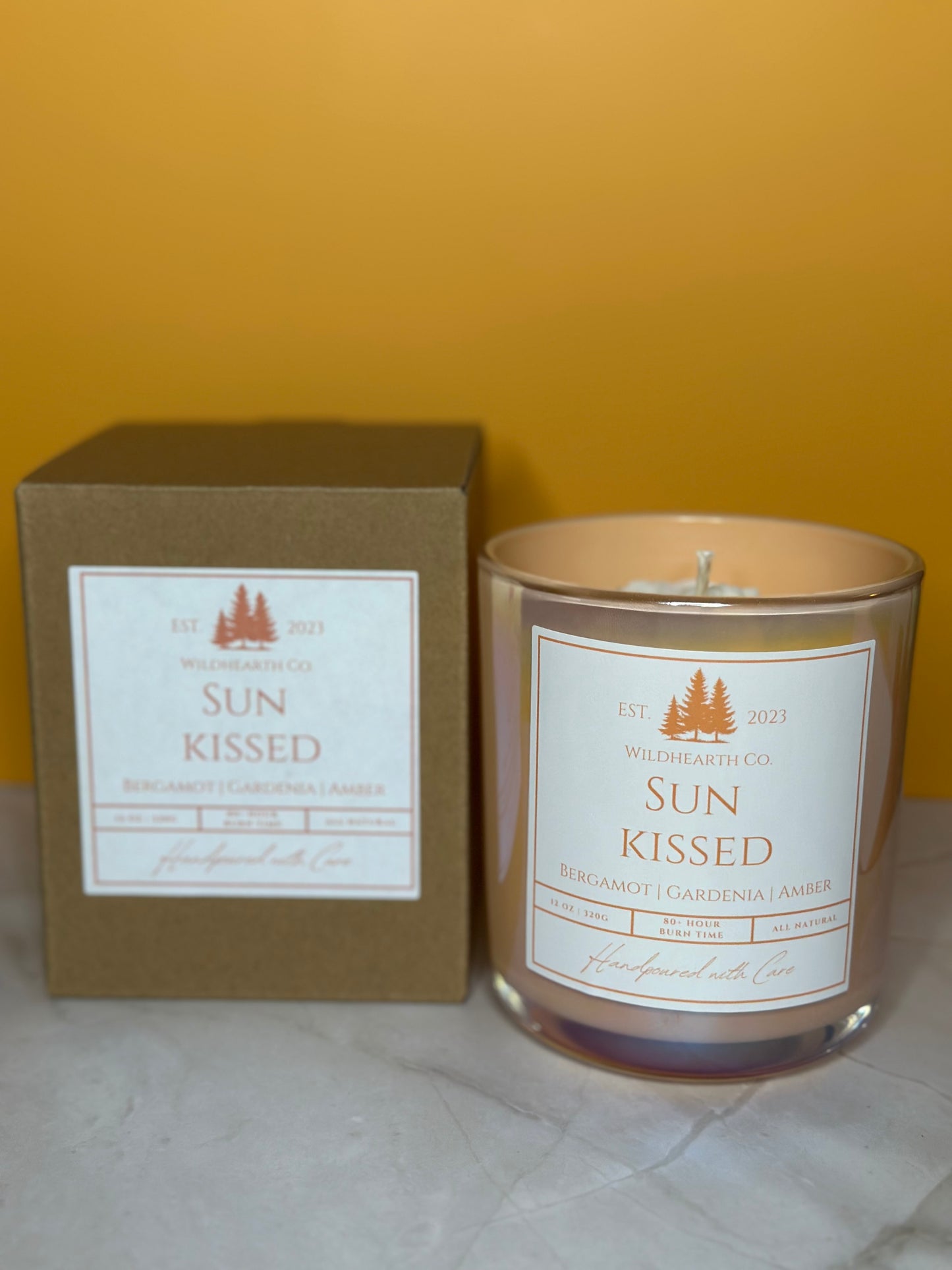 Sun Kissed coconut soy and beeswax candle in amber jar with gardenia, amber, and bergamot scent.